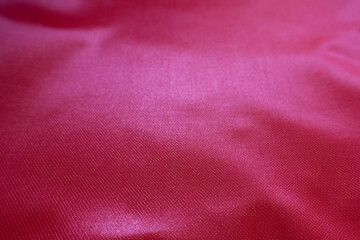 Wall Mural - Closeup of vivid reddish pink satin polyester fabric
