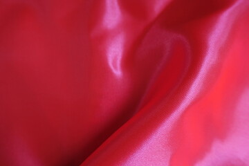 Wall Mural - Soft fold on vibrant reddish pink satin polyester fabric