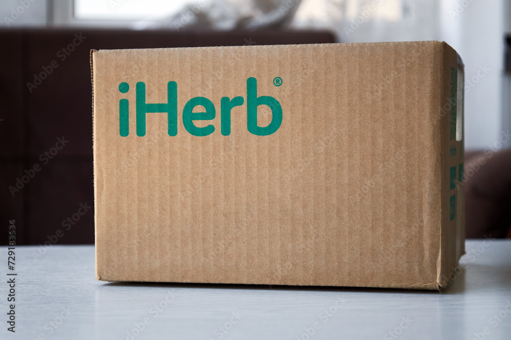 Brown Cardboard Box With Green Logo Iherb Store On Table Online