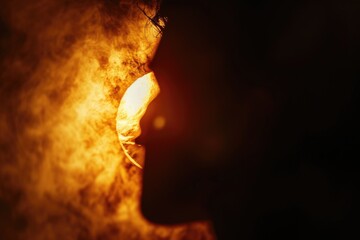 Poster - A close-up photograph capturing the intense expression on a person's face against a backdrop of roaring flames.