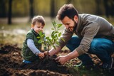 Fototapeta Miasta - father and son planting a tree together. Family quality time together. Fathers day. Dad and his boy doing good deeds. Future and eco concept.