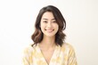 © Surachetsh - Pajama Chic, charm of a young woman in a joyful pose, donning stylish cotton silk pajamas against a solid studio background. Generative AI.
