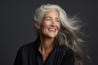 © Wararat - A beautiful aging mature woman with long gray hair and happy smiling touch face.
