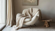 A luxuriously soft cashmere throw is artfully draped over a modern chair, creating an ambiance of relaxed sophistication, ideal for content related to interior design or fashion lifestyle spreads.