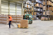 © industrieblick - warehouse worker in a forwarding agency - interior with forklift - transport and storage of goods