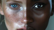 © Laura - close-up portrait of two people, half portrait of a caucasian woman and the other half of an african woman