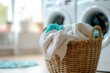 Wicker basket with clean clothes in laundry room, closeup view