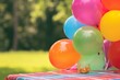 empty table space, colorful bbq picnic scene with balloons out of focus