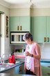 © Austockphoto - Senior woman using a jug to boil water and make a cup of tea