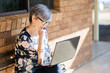 © Austockphoto - woman working on laptop outside thinking
