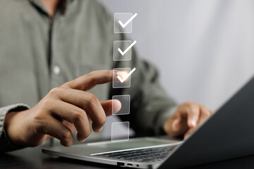 Canvas Print - Business performance monitoring and evaluation concept, Take an assessment, Business man using laptop online checklist survey, Filling out digital checklist, Questionnaire with checkboxes.