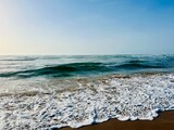 Fototapeta Łazienka - Seashore background, sea horizon, sea foam at the sandy coast
