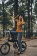 © ARMMY PICCA - Happy young Asian woman while riding a bicycle in a city park. She smiled using the bicycle of transportation. Environmentally friendly concept.