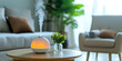 Humidifier on the table at home and spreading steam into the living room. Portable humidifier for clean air purification electric aroma diffuser.