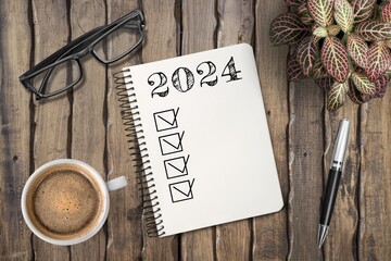 Wall Mural - New year 2024 resolutions on paper on desk.