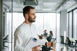 © standret - Professional male manager is in front of colleagues. Team of office workers are together indoors