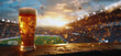 A glass of beer in a sports stadium at sunset. Beer with a foamy head against a blurred background