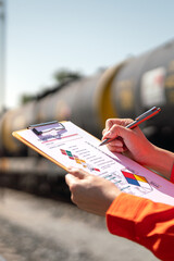 Wall Mural - action of an engineer is checking on chemical hazardous material checklist form with background of t