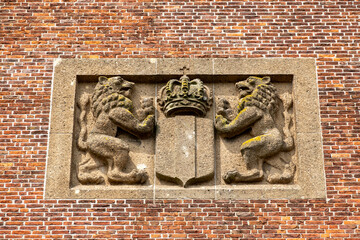 Wall Mural - Plaque with Dutch lions on facade of former city hall of Medemblik, Noord-Holland, Netherlands