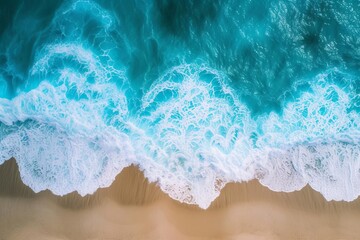 Wall Mural - Aerial view of ocean waves on the beach Providing a beautiful natural background of summer vacations Aerial top-down view of the sea with blue water waves