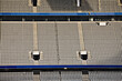 © MACO - Rows of empty stadium seats.