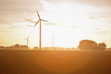 Windmills In The Landscape At Sunset. Munich, Germany