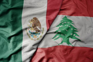 Wall Mural - big waving national colorful flag of lebanon and national flag of mexico .