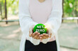 sustainable living with a hand holding a green ball, reflecting environmental, social, and governance (ESG) values, promoting the net zero concept for a greener future.