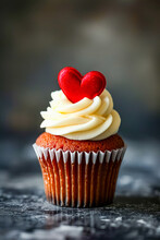 Cupcake With White Frosting And Two Red Hearts On Top Of It.