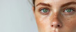 © Ai Studio - A young woman's freckled face, close-up with a gaze that's both intense and tranquil, a portrait of natural beauty