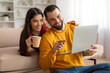 © Prostock-studio - Surfing Internet. Young Couple Relaxing With Laptop And Coffee At Home
