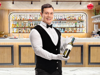 Canvas Print - Waiter holding a bottle of white wine