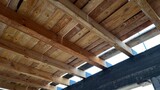 Fototapeta Krajobraz - New wooden ceiling on the new house built in progress. Wooden construction upon the first floor.