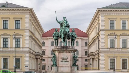 Canvas Print - Monument Reiterdenkmal of King Ludwig I of Bavaria timelapse, which is located at the Odeosplatz in Munich, Germany. Front view with historic buildings on a background.