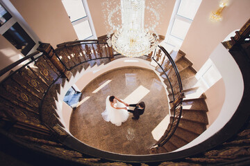 Wall Mural - groom and bride with a bouquet, posing in their wedding day. Enjoy a moment of happiness and love.