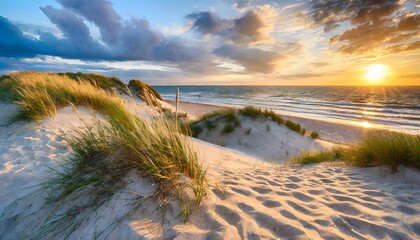 sand dunes on the beach at sunset