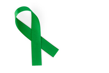 Wall Mural - Green ribbon, symbol of social awareness, isolated on white background, top view. World Cancer Day. copy space.