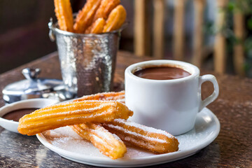 Canvas Print - A delightful treat of golden churros paired with creamy hot chocolate, perfect for dessert or a sweet snack