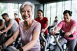 © Danko - Active Asia senior old woman people training exercise on stationary bike for fit healthy at home gym.