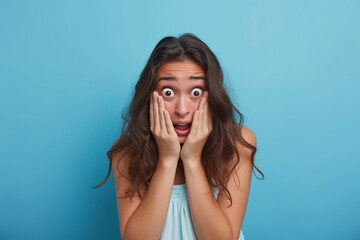 Nervous woman in studio with oops reaction on blue background. Mistake, sorry and female overwhelmed by fake news, drama or secret with regret.