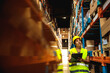 © Davor - Young woman warehouse supervisor with clipboard