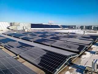 Solar panels covered with frost on a sunny frosty day at sunrise
