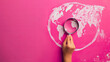 Hand holding a magnifying glass over a chalk drawing of the Earth on a pink background