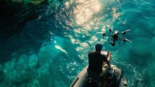 Man Operating A Drone Over Clear Ocean Waters From An Inflatable Boat
