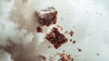  A Piece Of Brownie Sitting On Top Of A Pile Of Brownie Next To A Bag Of Brownies On Top Of A Pile Of White Clouds Of Smoke.