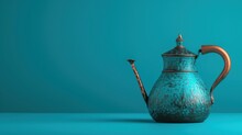 A Blue Teapot With A Brown Handle And A Wooden Stick Sticking Out Of The Top Of It, Sitting On A Blue Surface, With A Teal Background.