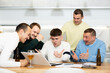 © JackF - Group of football fans drinking beer and watching football match on a laptop at home