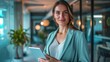 © DreamPointArt - A confident businesswoman presenting impressive results on a digital tablet in a modern co-working office space.