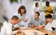 © JackF - Group of men play board games during a friendly meeting indoors