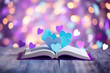 Open book with two hearts in pastel pink and blue. The concept of romantic poetry, stories, Valentine's Day and gift books.